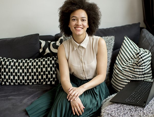 Attractive young woman working on laptop at home